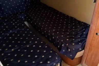 Knot On Call Yacht Photos Pics Interior cabin of 2007 Regal Commodore 4060 with star-patterned bedding.