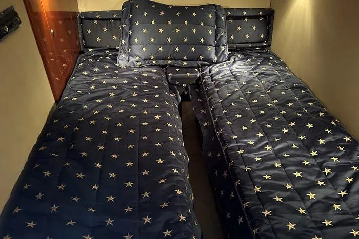 Knot On Call Yacht Photos Pics Twin beds with star-patterned bedding in a 2007 Regal Commodore 4060 cabin.