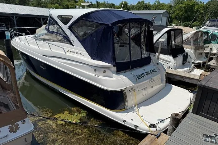 Knot On Call Yacht Photos Pics 2007 Regal Commodore 4060 yacht docked, featuring sleek design and blue canopy.