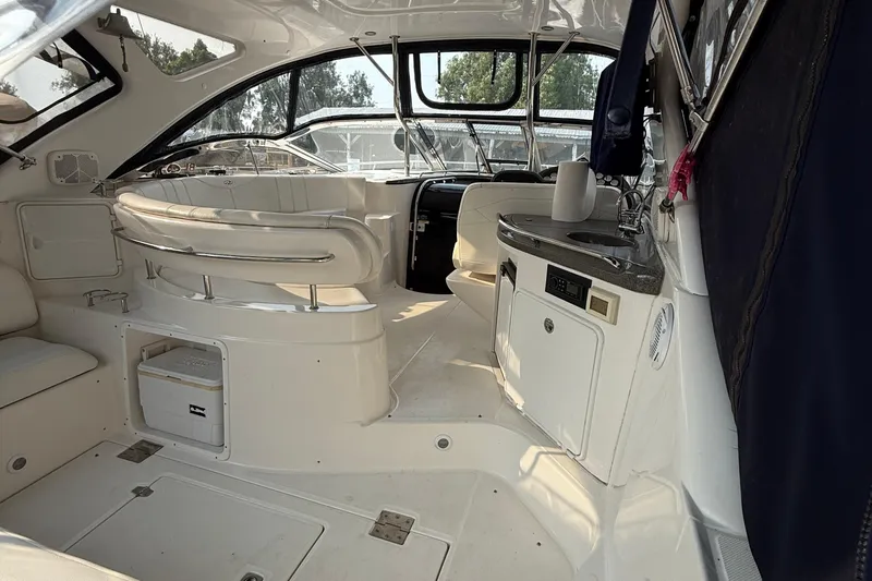 Knot On Call Yacht Photos Pics 2007 Regal Commodore 4060 yacht interior with seating, kitchenette, and helm.