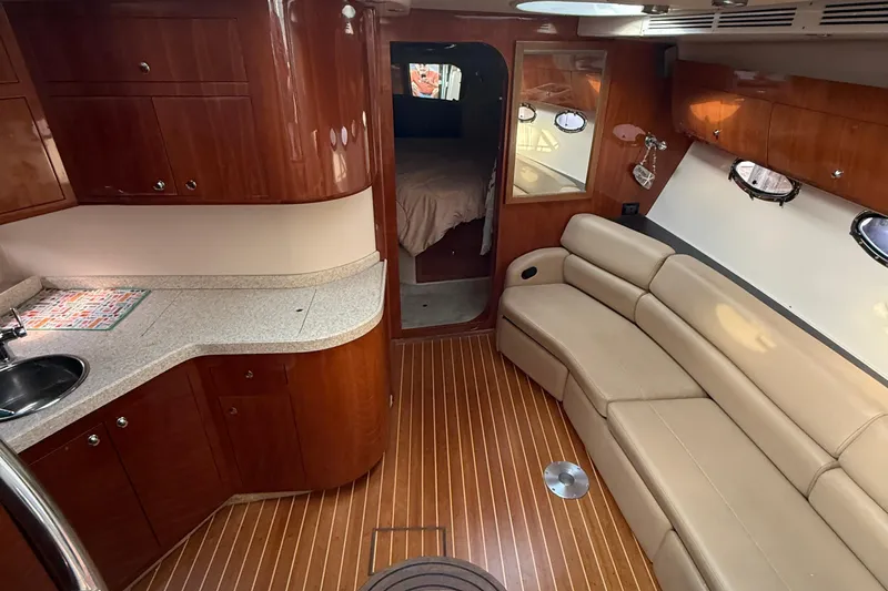 Knot On Call Yacht Photos Pics Luxurious interior of 2007 Regal Commodore 4060 yacht with wood cabinetry and leather seating.