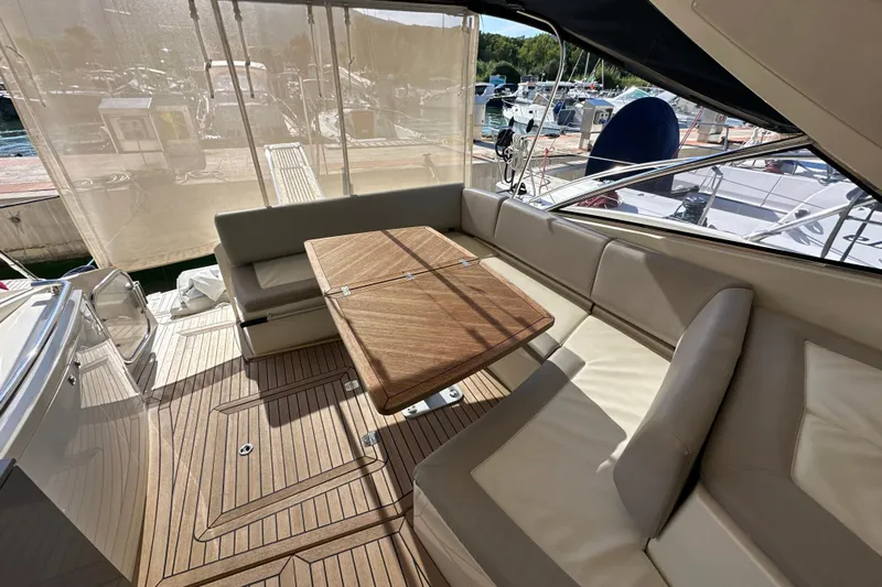  Yacht Photos Pics Luxurious seating area on 2011 Azimut Atlantis 40 yacht with wooden table and marina view.