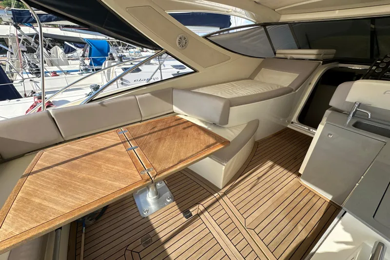  Yacht Photos Pics Luxurious interior of 2011 Azimut Atlantis 40 yacht with wooden table and seating.