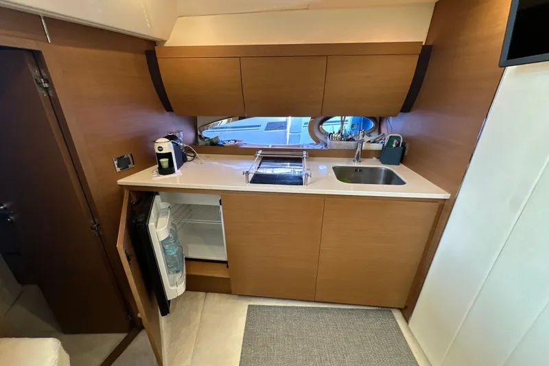  Yacht Photos Pics Modern kitchen area in 2011 Azimut Atlantis 40 yacht with wood cabinetry and compact appliances.