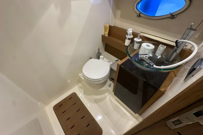  Yacht Photos Pics Bathroom interior of 2011 Azimut Atlantis 40 yacht, featuring modern fixtures and porthole window.