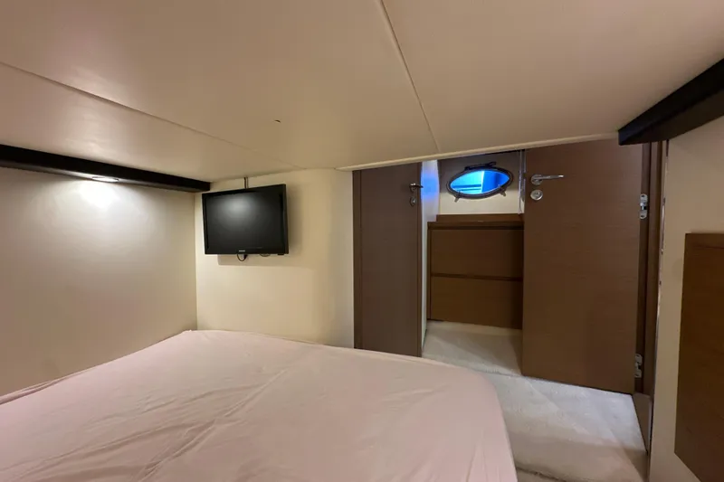  Yacht Photos Pics Interior cabin of 2011 Azimut Atlantis 40 yacht with bed and wall-mounted TV.