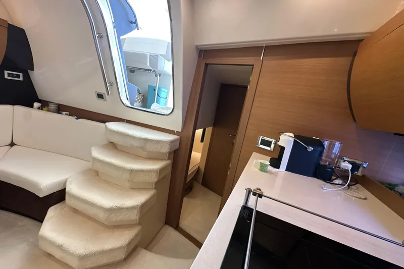 Yacht Photos Pics Interior of 2011 Azimut Atlantis 40 yacht with stairs, seating, and kitchenette.