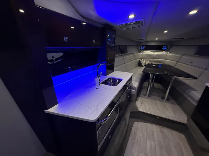  Yacht Photos Pics Luxurious interior of 2017 Formula 370 FX boat with modern kitchen and seating area.