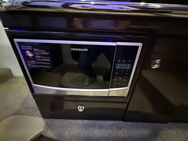  Yacht Photos Pics Frigidaire microwave in 2017 Formula 370 FX boat interior, sleek black design.