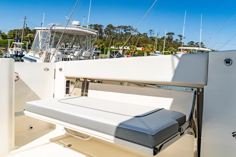 Miss Morgan III Yacht Photos Pics 2021 Pursuit 365DC boat with foldable seating, docked in a marina under clear blue skies.