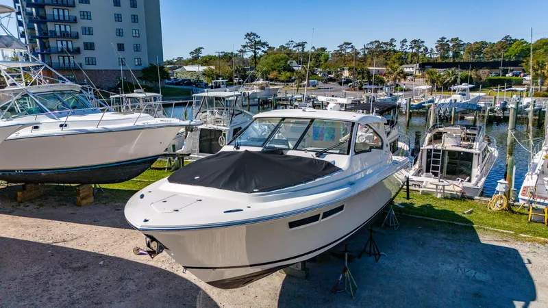Miss Morgan III Yacht Photos Pics 2021 Pursuit 365DC boat docked at a marina, surrounded by other vessels.
