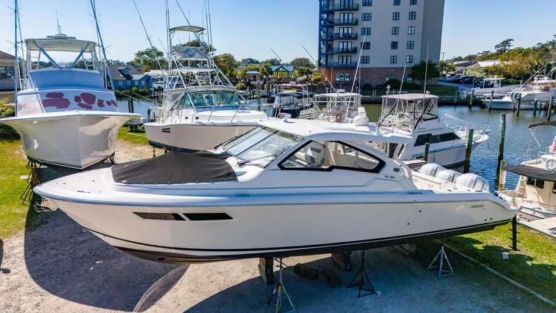 Miss Morgan III Yacht Photos Pics 2021 Pursuit 365DC boat docked at marina with other vessels in background.