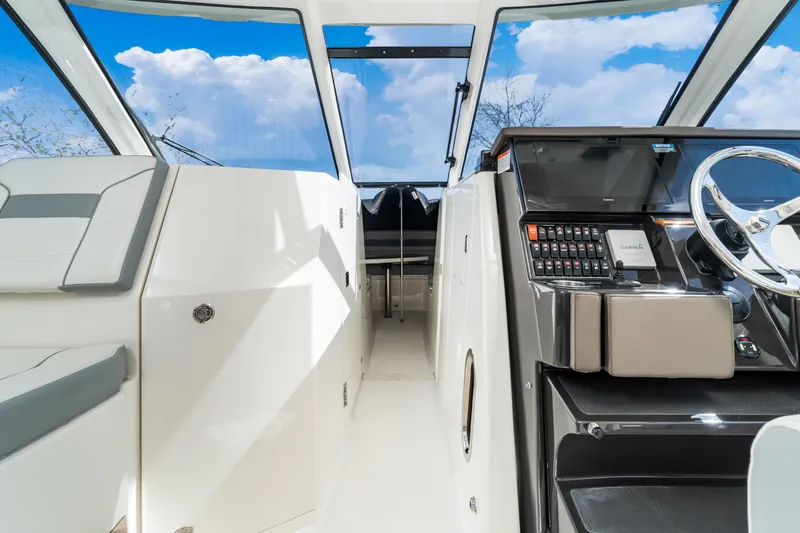 Miss Morgan III Yacht Photos Pics 2021 Pursuit 365DC boat interior with modern helm and panoramic windows.