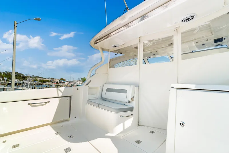 Miss Morgan III Yacht Photos Pics 2021 Pursuit 365DC boat interior with seating, white finish, and clear blue sky.