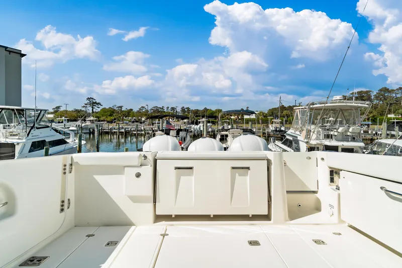 Miss Morgan III Yacht Photos Pics 2021 Pursuit 365DC boat docked at a marina under a partly cloudy sky.