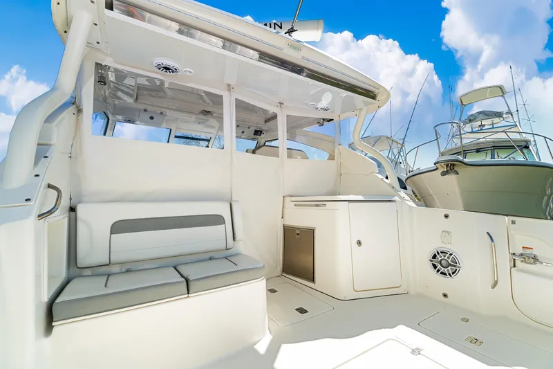 Miss Morgan III Yacht Photos Pics 2021 Pursuit 365DC boat interior with seating and storage, under a clear blue sky.