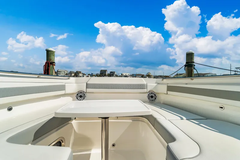 Miss Morgan III Yacht Photos Pics 2021 Pursuit 365DC boat interior with seating, table, and clear blue sky.
