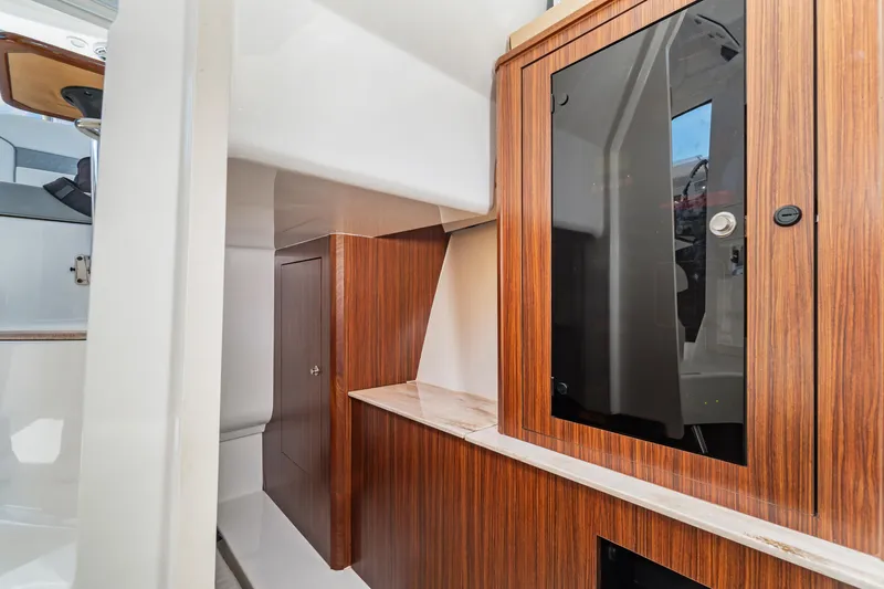 Miss Morgan III Yacht Photos Pics 2021 Pursuit 365DC interior with wood cabinetry and modern design elements.
