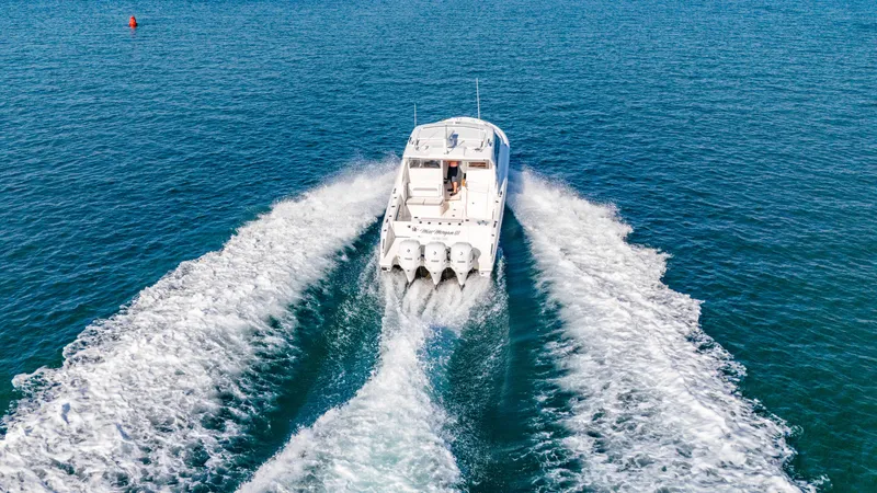 Miss Morgan III Yacht Photos Pics 2021 Pursuit 365DC boat cruising on open blue water, leaving a wake trail.