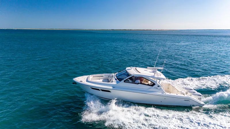 Miss Morgan III Yacht Photos Pics 2021 Pursuit 365DC boat cruising on clear blue ocean waters.