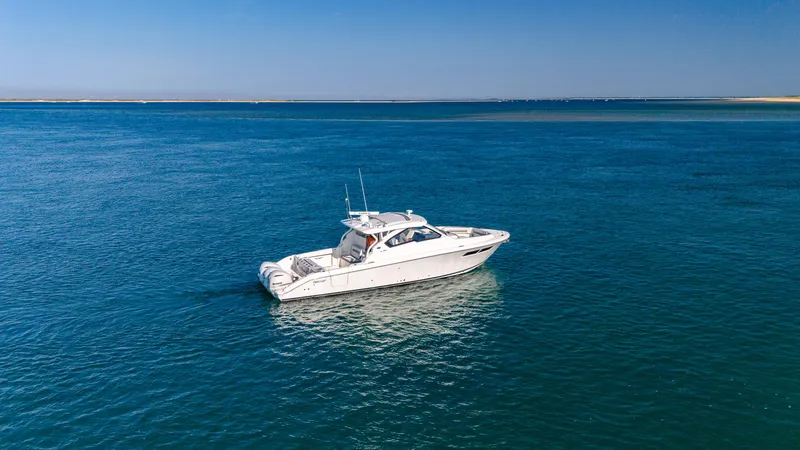 Miss Morgan III Yacht Photos Pics 2021 Pursuit 365DC boat on calm blue ocean waters under clear sky.