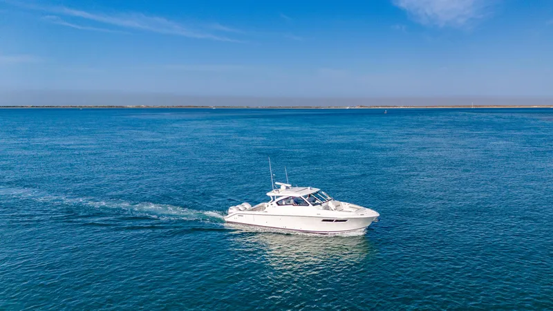 Miss Morgan III Yacht Photos Pics 2021 Pursuit 365DC boat cruising on open blue water under clear sky.