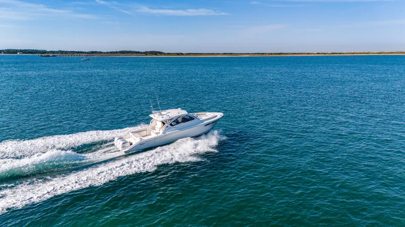 Miss Morgan III Yacht Photos Pics 2021 Pursuit 365DC boat cruising on open blue water under clear skies.