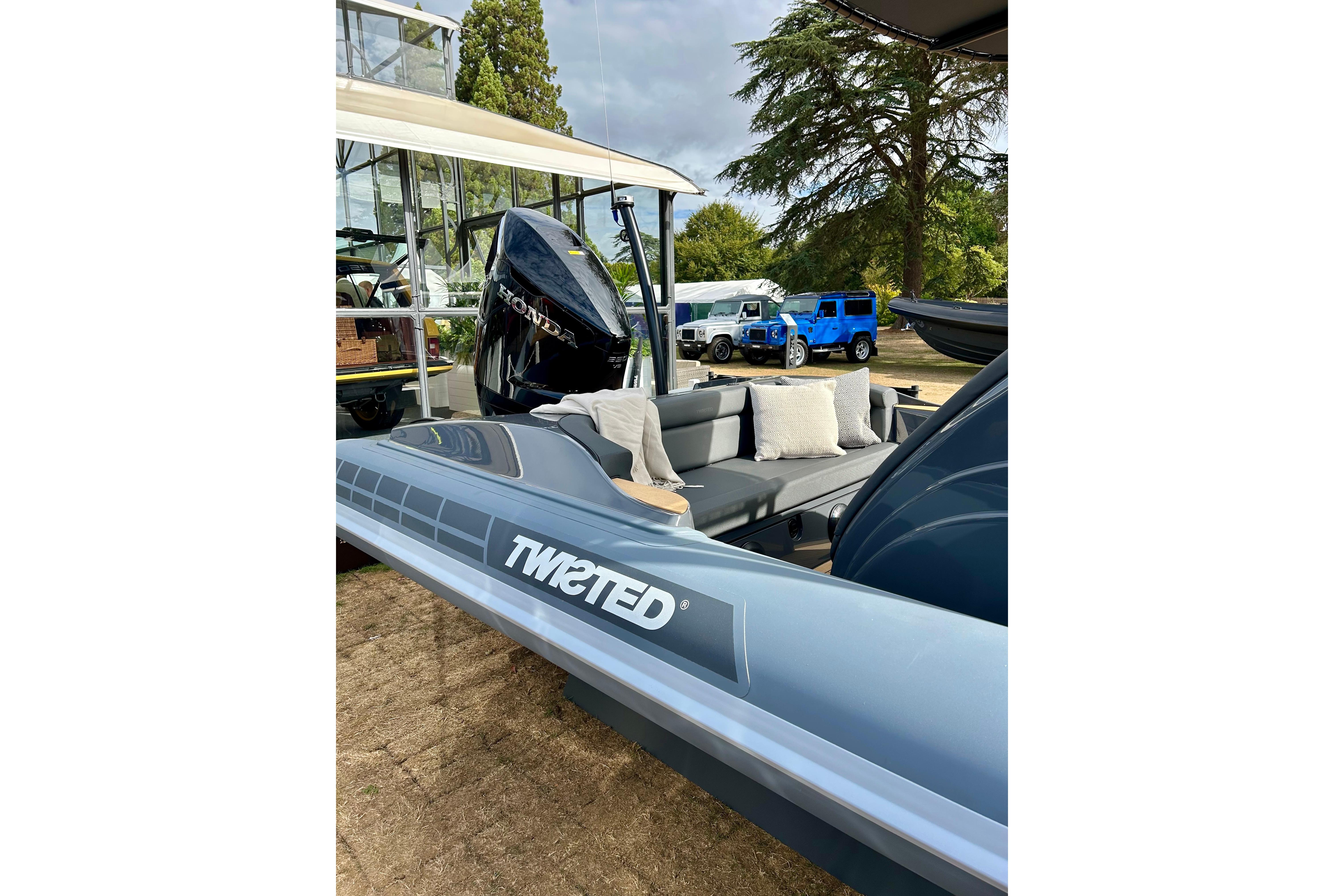 2025 Twisted 28 Sport boat with Honda engine, outdoor display setting.