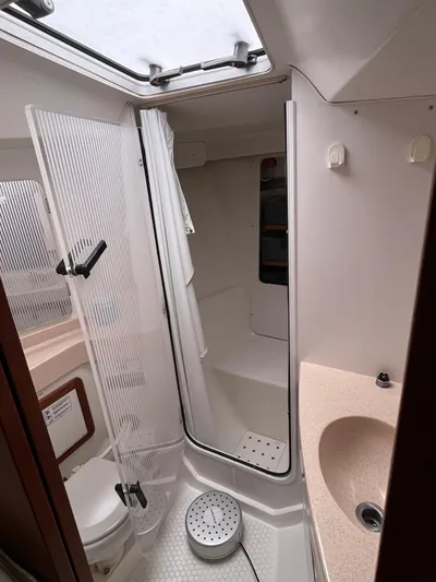 Moonshadow Yacht Photos Pics Bathroom interior of a 1998 Catalina 42 MkII sailboat, featuring a shower and sink.