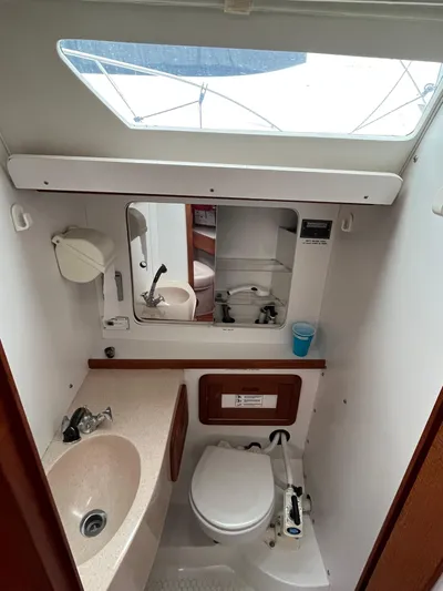 Moonshadow Yacht Photos Pics 1998 Catalina 42 MkII yacht bathroom with sink, toilet, and mirror.