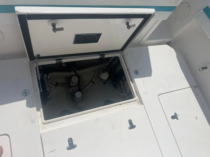  Yacht Photos Pics Open hatch on 2017 Intrepid 327 Cuddy boat, revealing internal components.