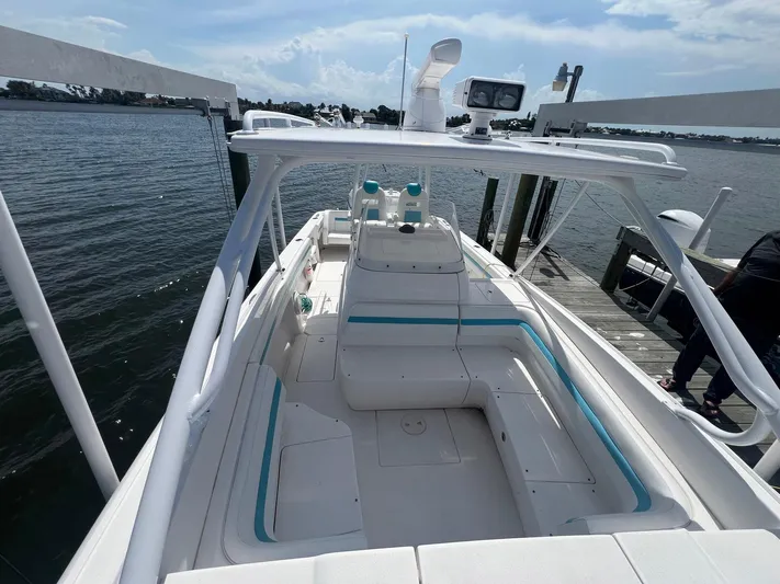  Yacht Photos Pics 2017 Intrepid 327 Cuddy boat docked, featuring spacious seating and sleek design.