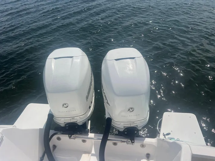 Yacht Photos Pics Twin outboard engines on a 2017 Intrepid 327 Cuddy boat, floating on water.