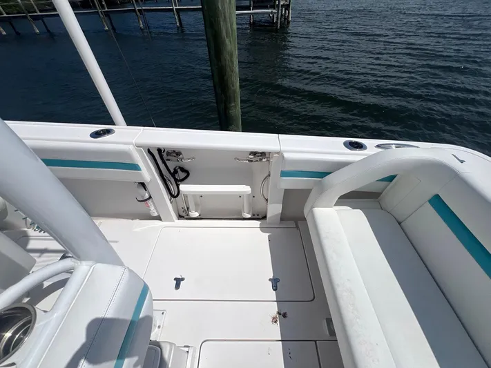  Yacht Photos Pics 2017 Intrepid 327 Cuddy boat interior with seating and water view.