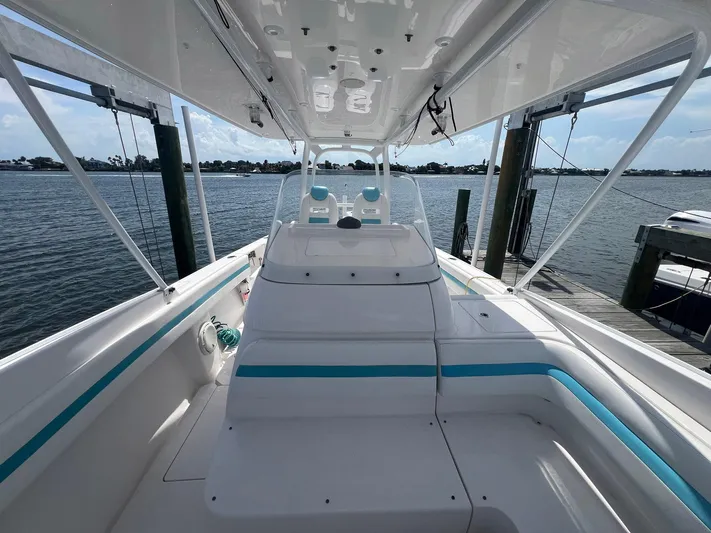  Yacht Photos Pics 2017 Intrepid 327 Cuddy boat interior at dock, showcasing seating and helm.