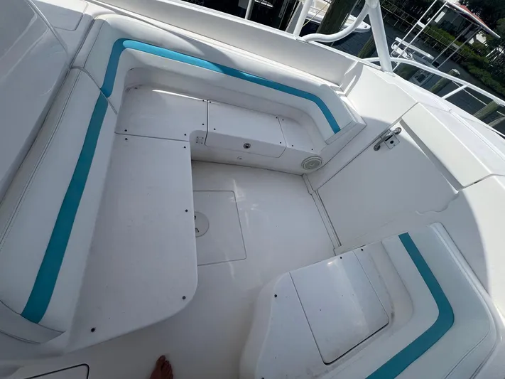  Yacht Photos Pics 2017 Intrepid 327 Cuddy boat interior with white and teal seating.