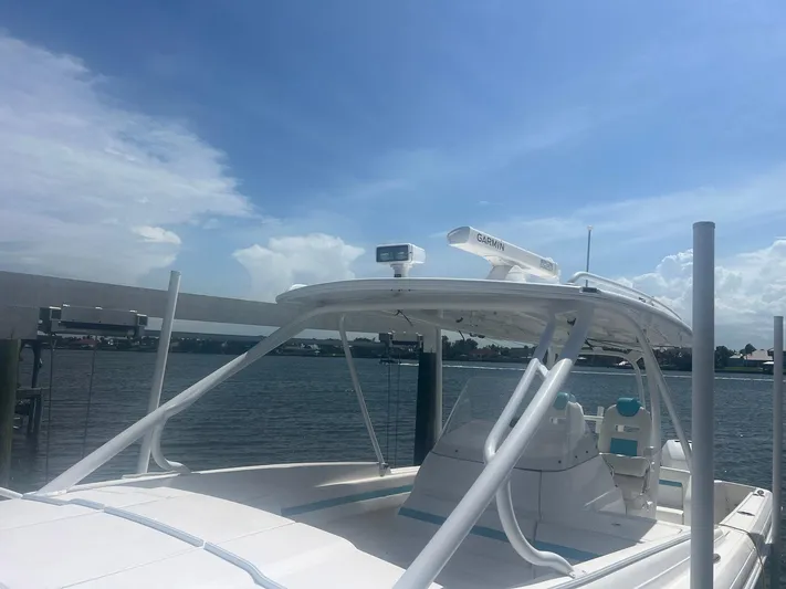  Yacht Photos Pics 2017 Intrepid 327 Cuddy boat docked under a clear blue sky.