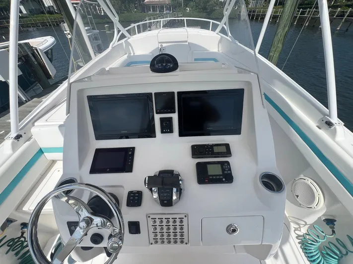  Yacht Photos Pics 2017 Intrepid 327 Cuddy boat dashboard with navigation screens and controls.