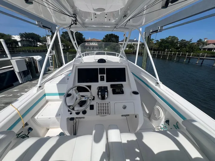  Yacht Photos Pics 2017 Intrepid 327 Cuddy boat cockpit with steering wheel and control panel.