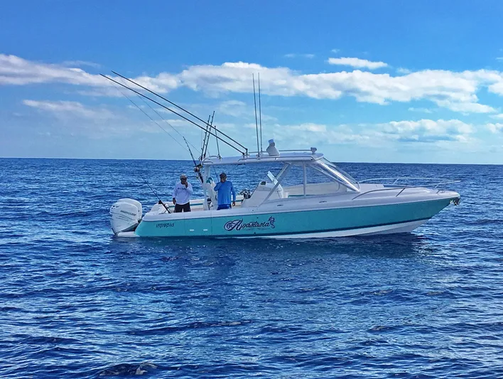  Yacht Photos Pics 2017 Intrepid 327 Cuddy boat on open sea with two people fishing.