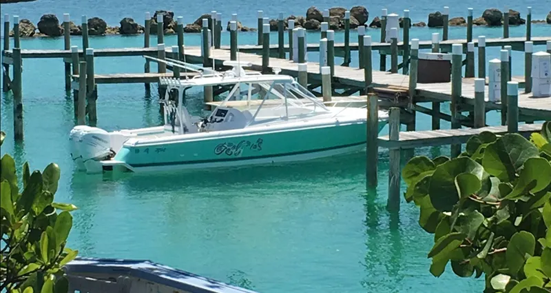  Yacht Photos Pics 2017 Intrepid 327 Cuddy boat docked in clear turquoise water.