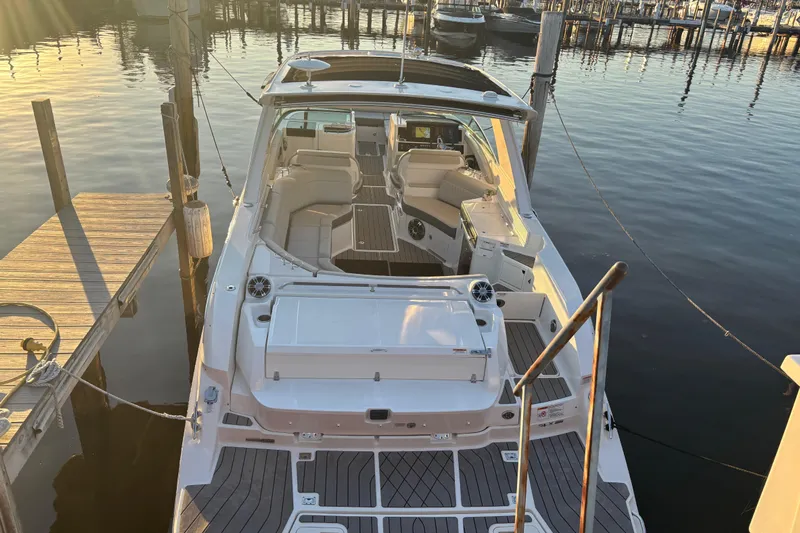  Yacht Photos Pics 2022 Searay SLX350 boat docked at sunset, showcasing luxurious seating and sleek design.