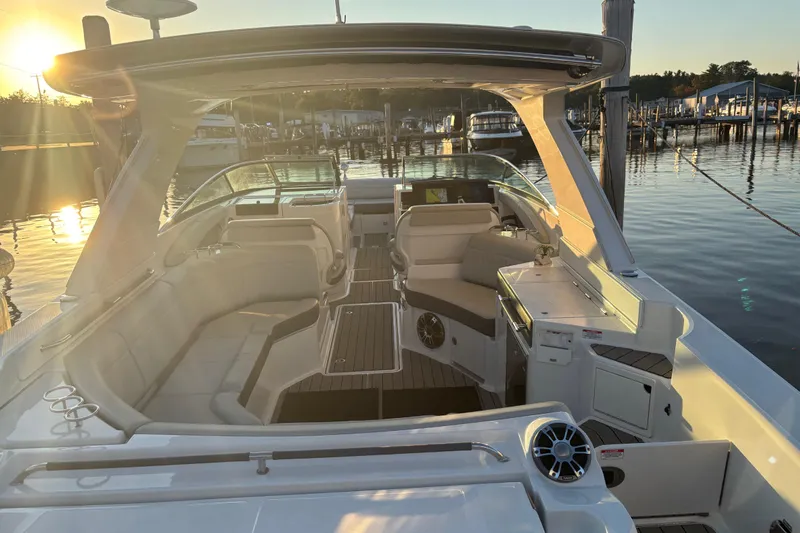  Yacht Photos Pics 2022 Searay SLX350 boat interior at sunset, docked in a serene marina.