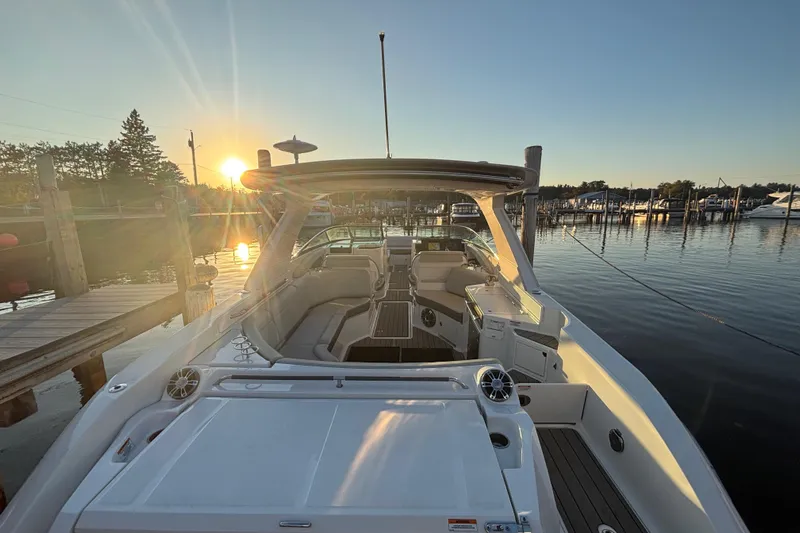  Yacht Photos Pics 2022 Searay SLX350 boat docked at sunset, showcasing luxurious interior and serene waterfront.