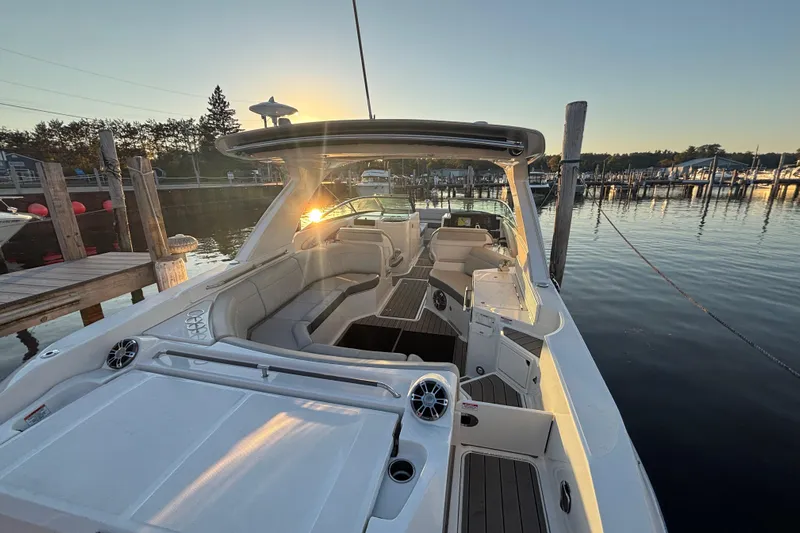  Yacht Photos Pics 2022 Searay SLX350 boat docked at sunset, featuring spacious seating and modern design.