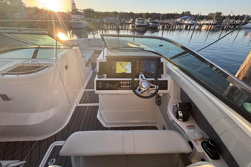  Yacht Photos Pics 2022 Searay SLX350 boat cockpit with modern controls, docked at sunset.
