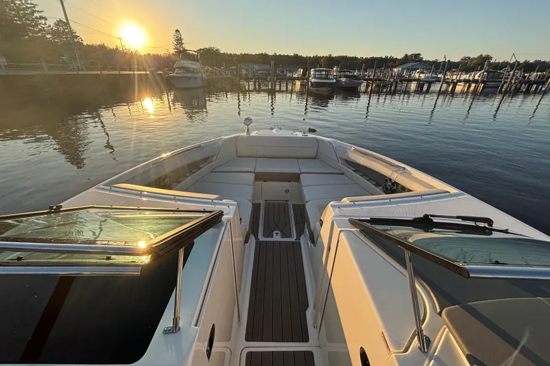  Yacht Photos Pics 2022 Searay SLX350 boat at sunset in a serene marina setting.