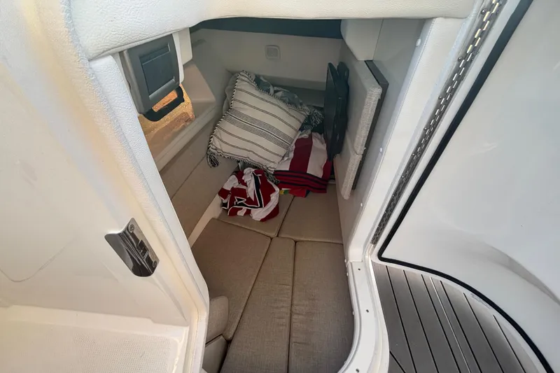  Yacht Photos Pics 2022 Searay SLX350 cabin interior with cushions and striped pillows.