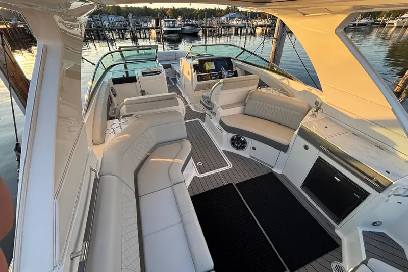  Yacht Photos Pics Luxurious 2022 Searay SLX350 boat interior with plush seating and modern amenities at a marina.