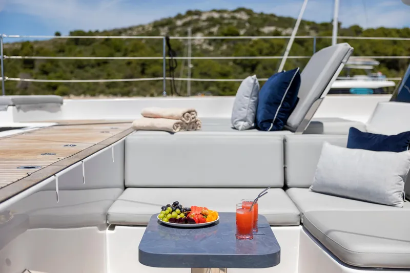 Mr. Si Yacht Photos Pics Luxurious Sunreef 60 Sail yacht deck with fruit platter and drinks, 2023 model.